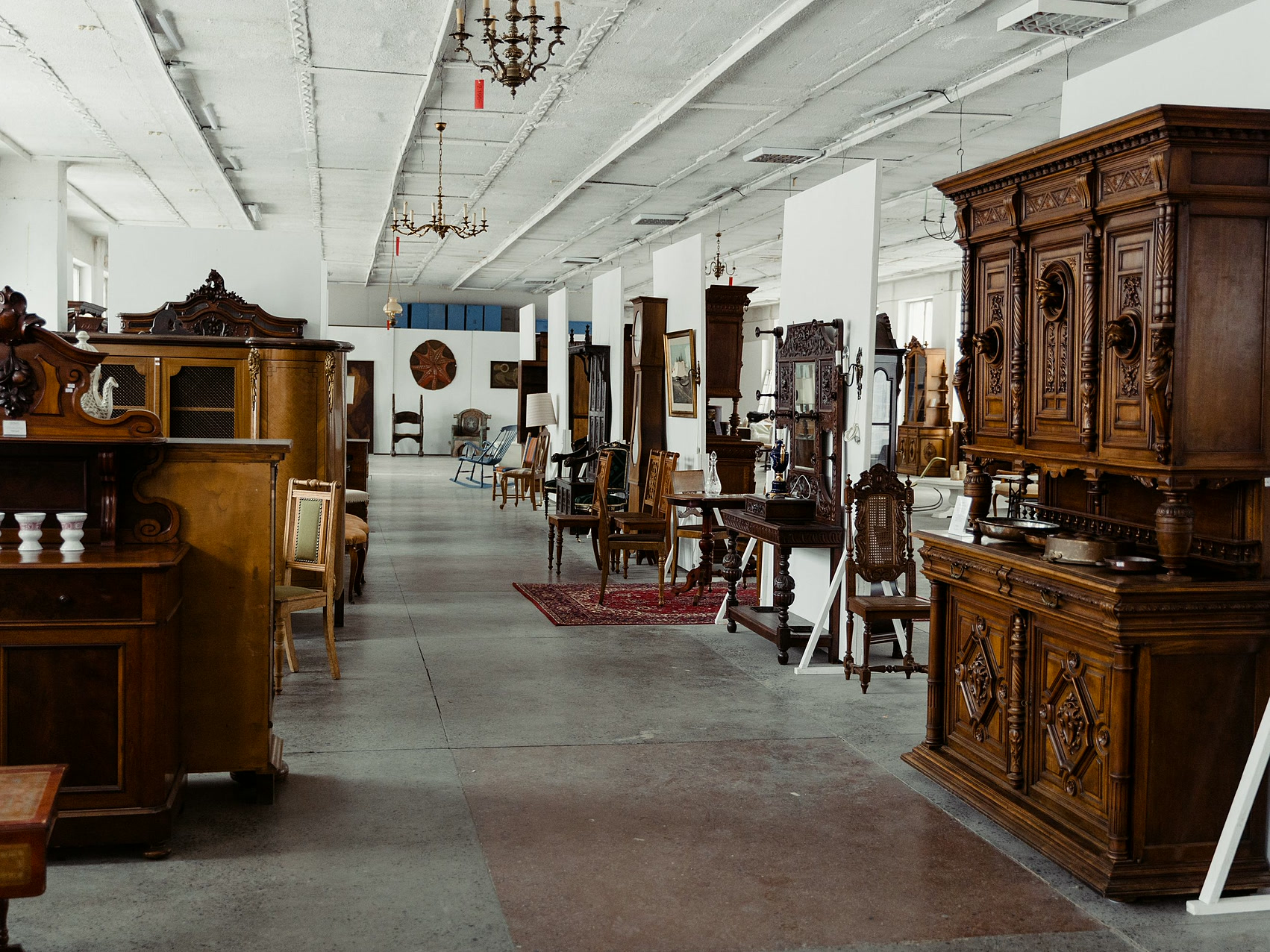 Display of antique wooden furniture in a classic showroom