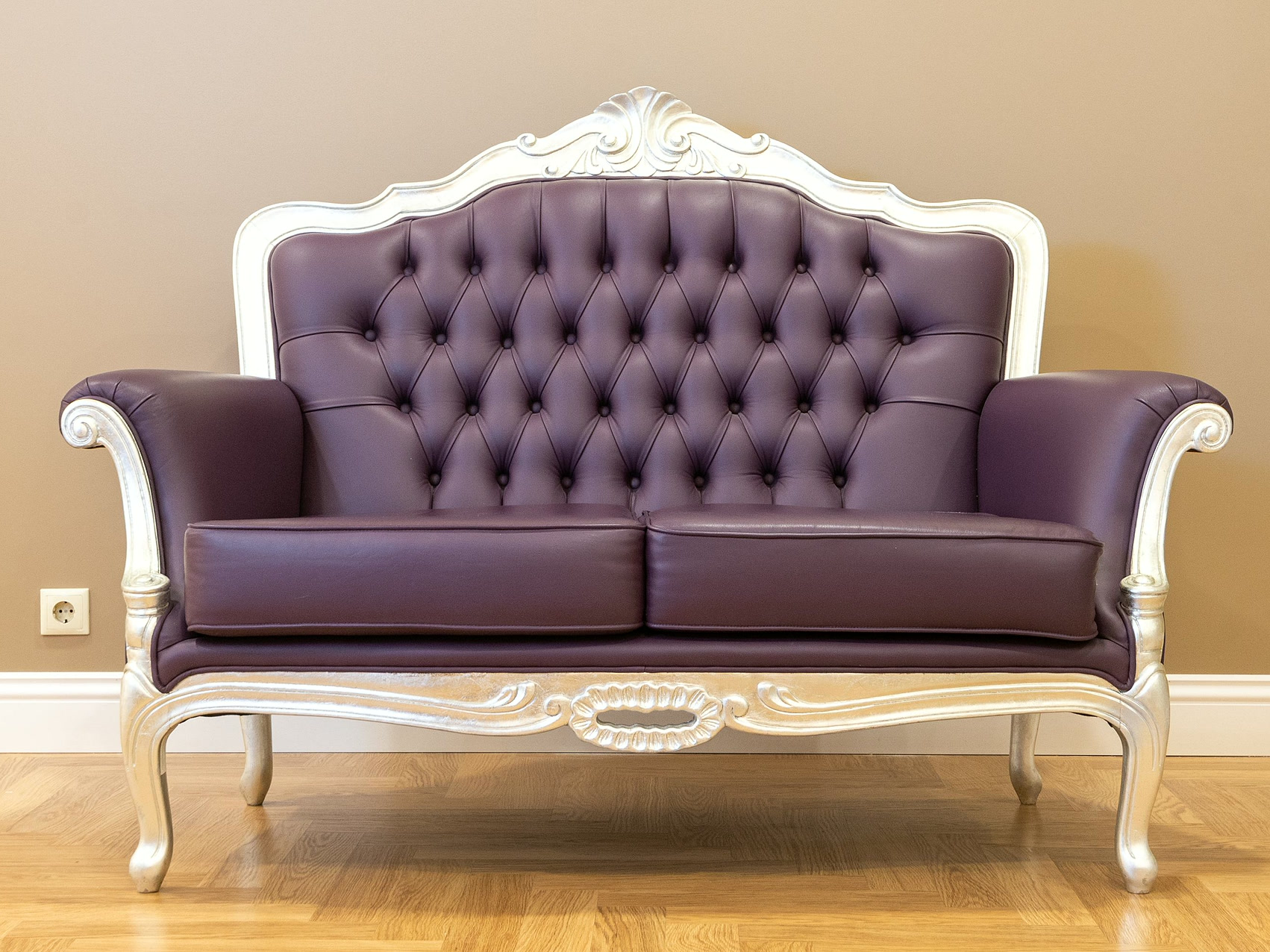 Tufted leather sofa on a wooden floor